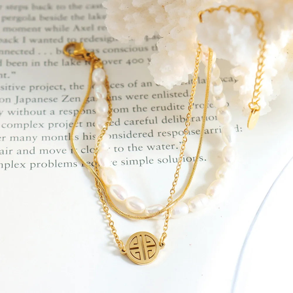 Pulsera de perlas de tres capas en acero de titanio