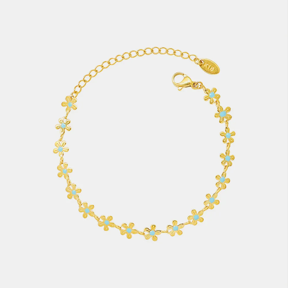 Pulsera Flor de Oro con Detalle Azul – Acero de Titanio
