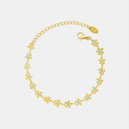 Pulsera Flor de Oro con Detalle Azul – Acero de Titanio
