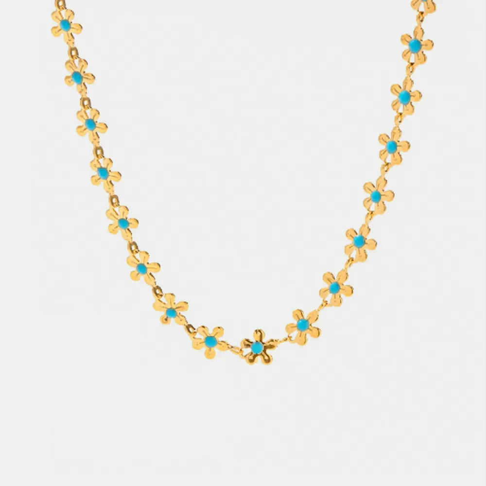 Colgante Flor de Oro con Detalle Azul – Acero de Titanio